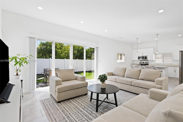 living area with recessed lighting and light tile patterned floors