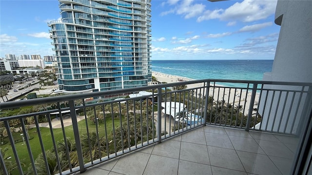 balcony featuring a water view and a beach view