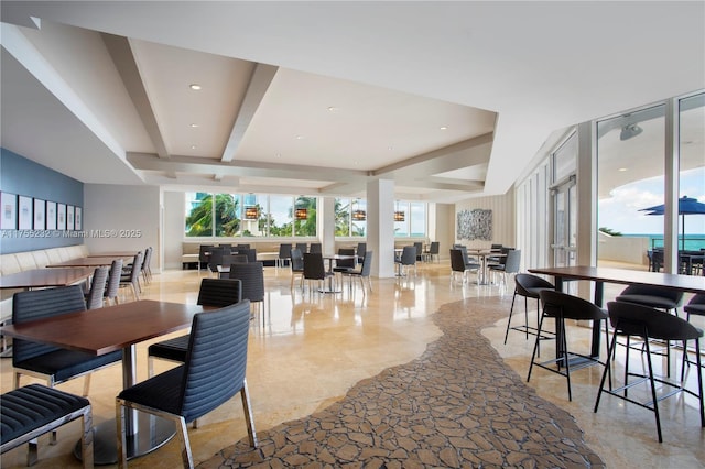 dining area featuring beam ceiling