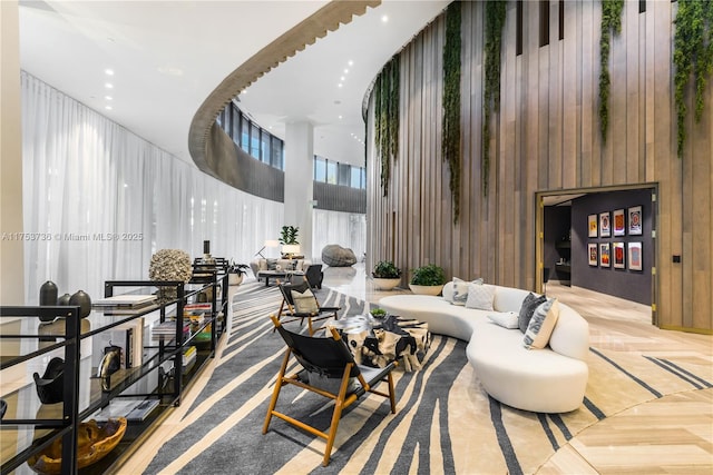 interior space featuring wood walls, a high ceiling, and recessed lighting