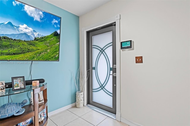 entryway featuring baseboards and light tile patterned floors