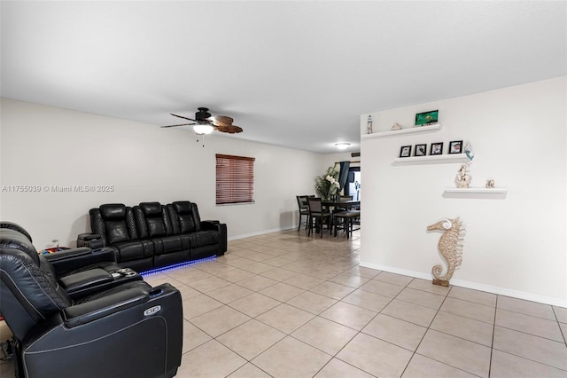 living room with baseboards, a ceiling fan, and light tile patterned flooring