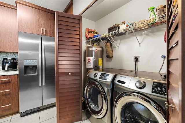 laundry area featuring laundry area, washer and clothes dryer, light tile patterned flooring, and electric water heater