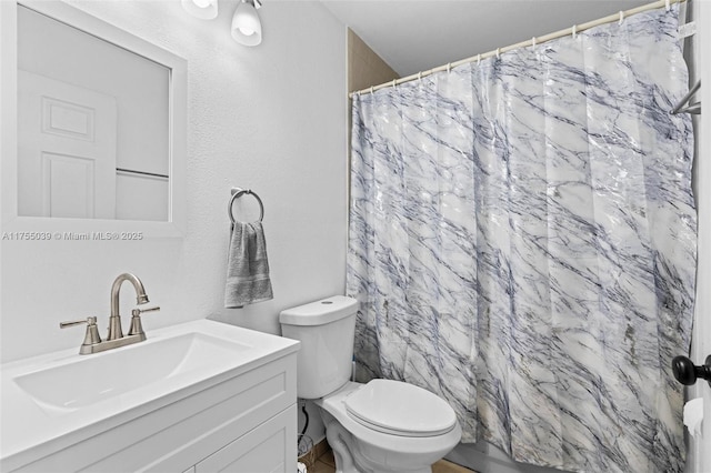 bathroom featuring toilet, a shower with curtain, and vanity