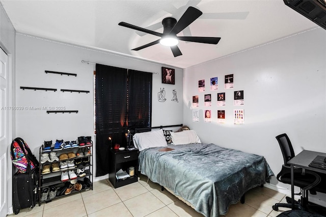 bedroom featuring ceiling fan and tile patterned flooring