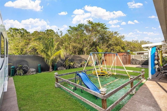 view of playground featuring a fenced backyard and a yard