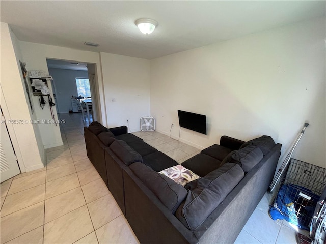 living room featuring visible vents and light tile patterned floors