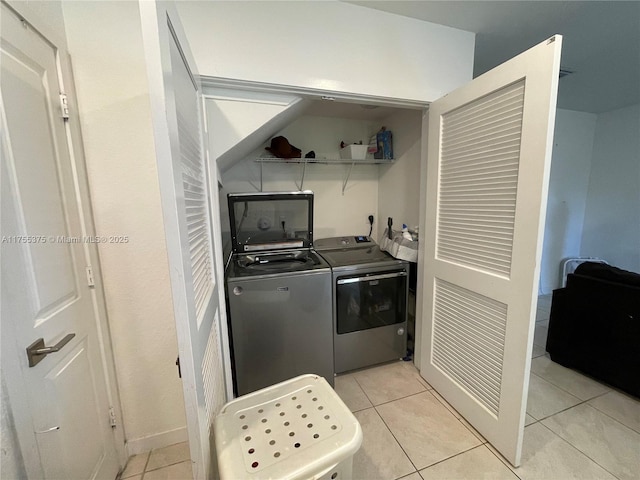 clothes washing area featuring light tile patterned floors, laundry area, and independent washer and dryer