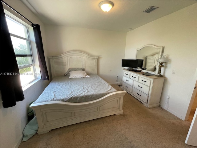 bedroom featuring light carpet, baseboards, and visible vents