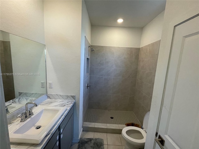 full bath with a stall shower, vanity, toilet, and tile patterned floors