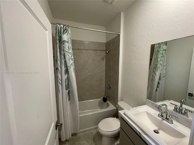 bathroom with a textured wall, vanity, toilet, and shower / tub combo with curtain