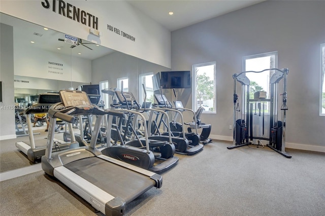 gym featuring a high ceiling, baseboards, and recessed lighting