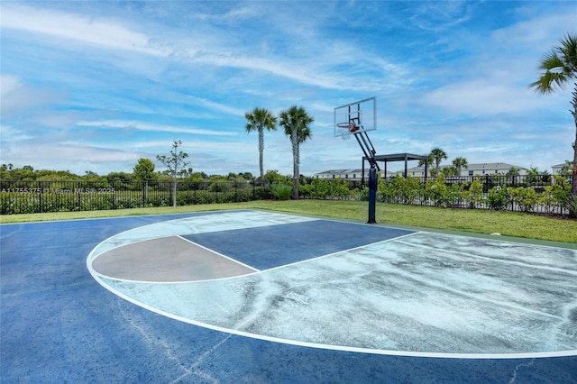 view of basketball court with community basketball court, fence, and a lawn