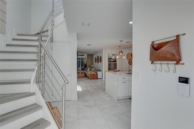 entrance foyer featuring light tile patterned floors and stairway