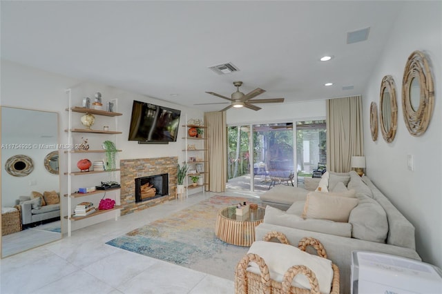 living room with a stone fireplace, a ceiling fan, visible vents, and recessed lighting