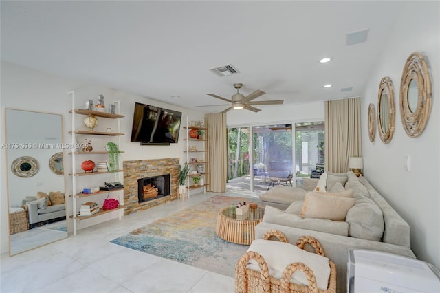 living area featuring recessed lighting, visible vents, light tile patterned flooring, ceiling fan, and a stone fireplace