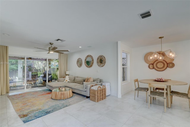 living area with recessed lighting, visible vents, and ceiling fan with notable chandelier