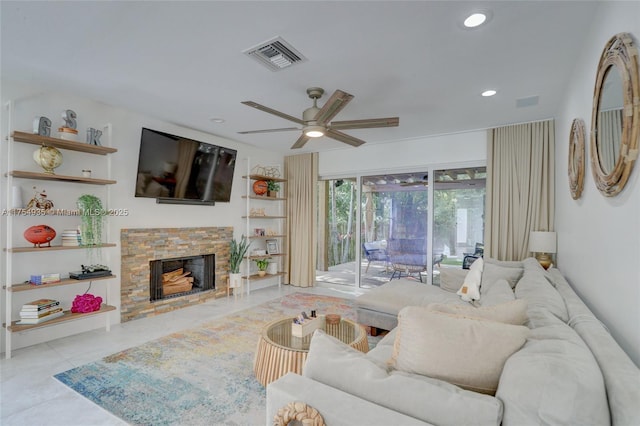 living area with visible vents, ceiling fan, tile patterned flooring, a stone fireplace, and recessed lighting