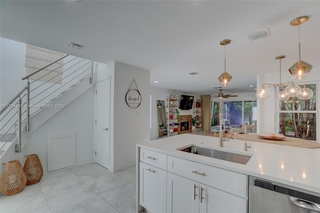 kitchen with a sink, visible vents, light countertops, and stainless steel dishwasher