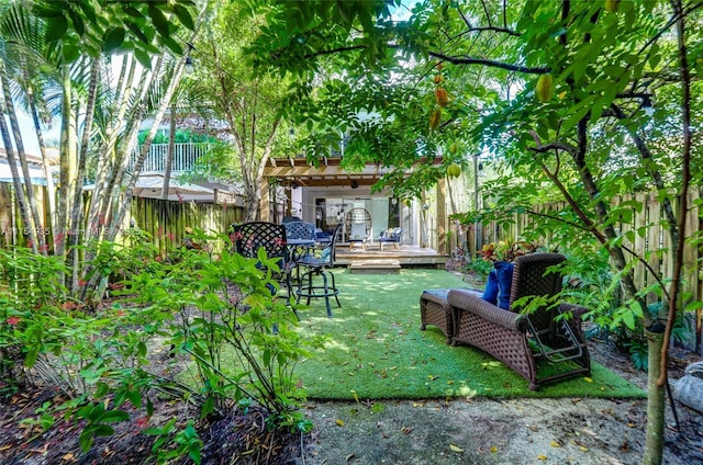 view of yard with a deck and a fenced backyard