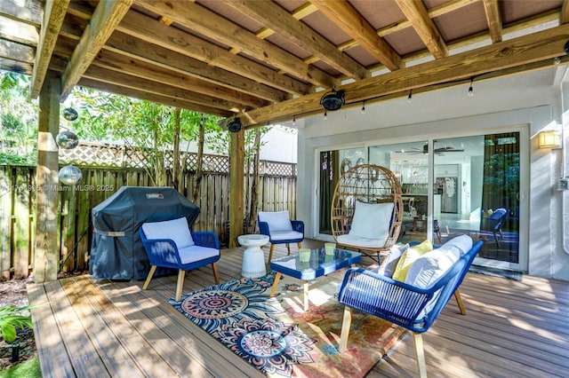 wooden terrace with fence, an outdoor hangout area, and area for grilling