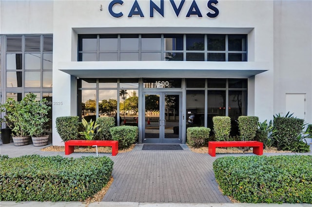 property entrance featuring french doors and stucco siding