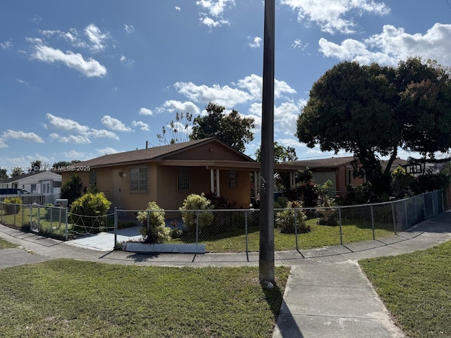 view of front of house featuring a front lawn, a fenced front yard, and stucco siding