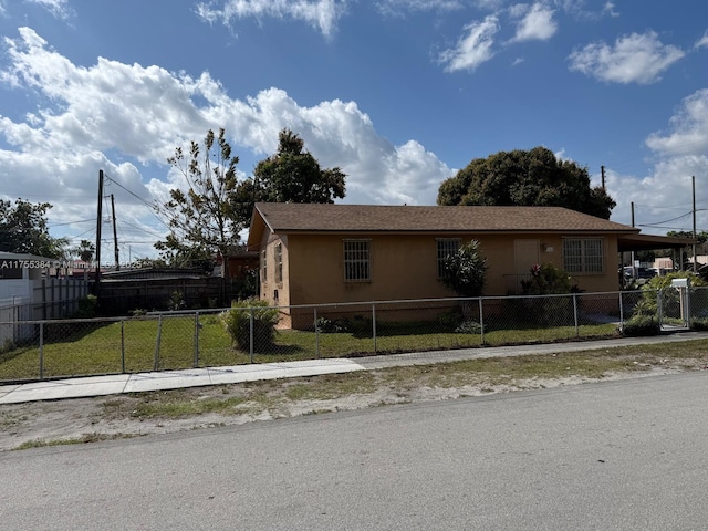 view of home's exterior with a fenced front yard, an attached carport, and stucco siding