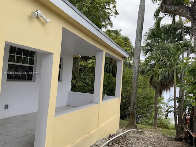 view of side of home featuring stucco siding