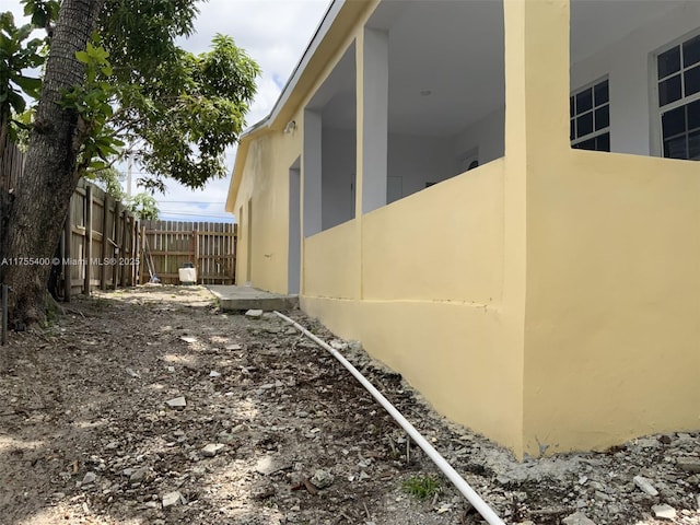 view of home's exterior featuring fence and stucco siding