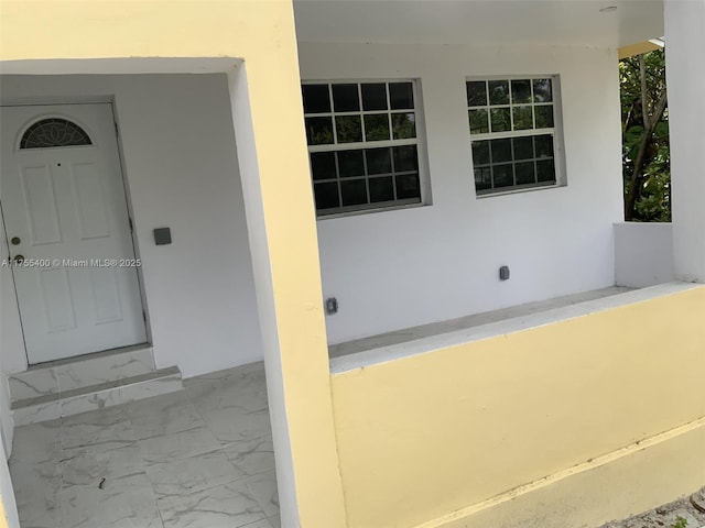 doorway to property with stucco siding