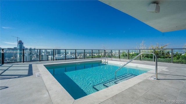 view of swimming pool with a patio and a swimming pool