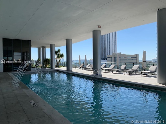 community pool featuring a view of city and a patio area