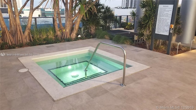 view of swimming pool with a community hot tub