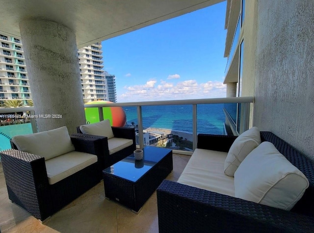 balcony featuring outdoor lounge area and a water view