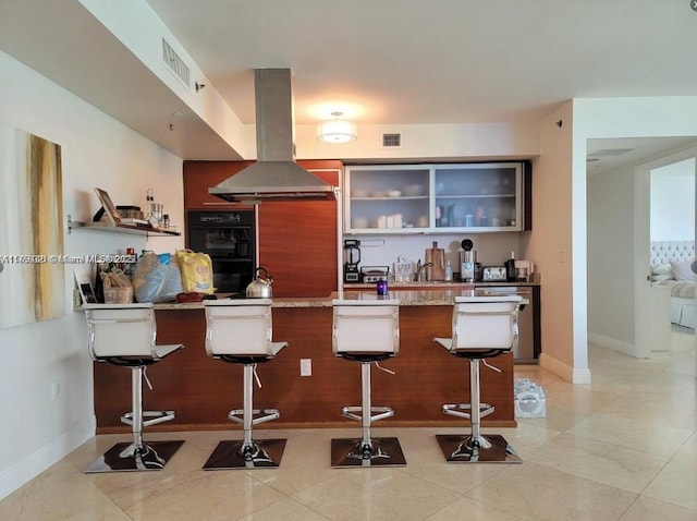 bar featuring visible vents, dishwasher, island range hood, and dobule oven black