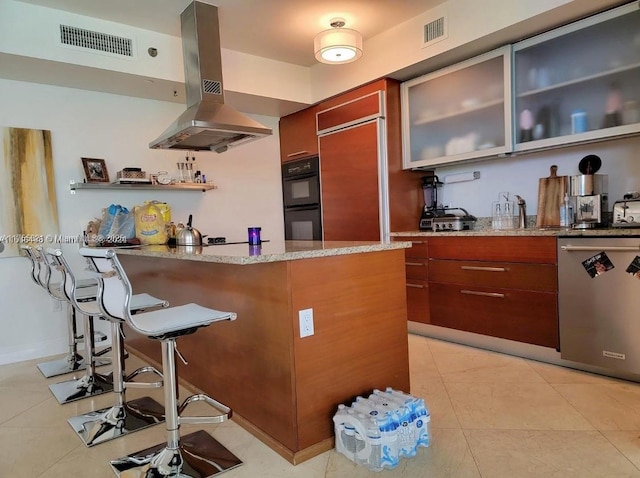 kitchen with light tile patterned floors, stainless steel dishwasher, visible vents, and island range hood