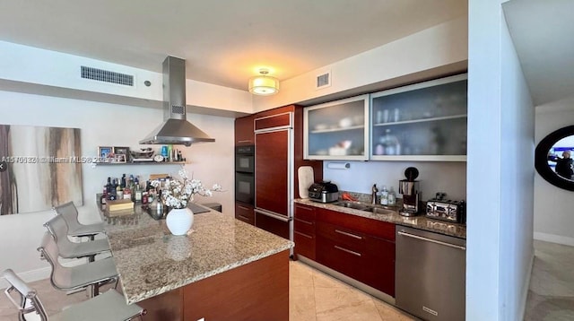 kitchen featuring dishwasher, wall chimney exhaust hood, a sink, and visible vents