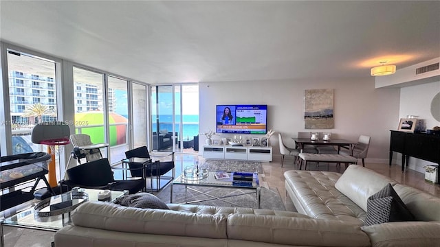 1800 S Ocean Dr Unit 1510, Hallandale Beach, FL 33009 - living room featuring expansive windows, baseboards, and tile patterned flooring