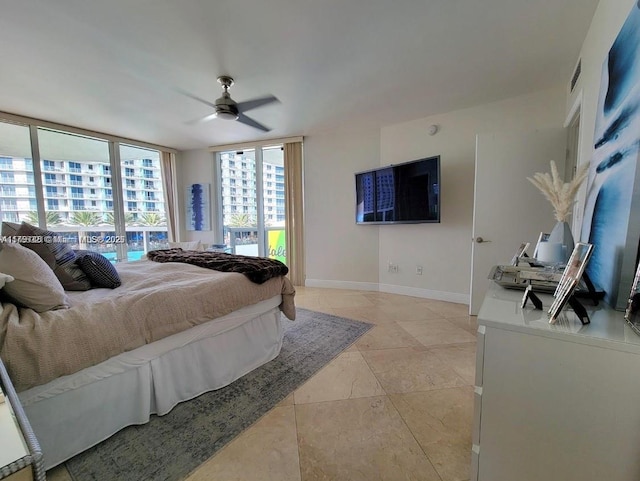 bedroom with a ceiling fan and baseboards