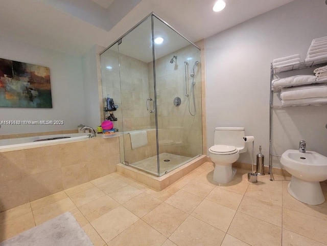 full bath featuring a garden tub, toilet, a stall shower, a bidet, and tile patterned flooring