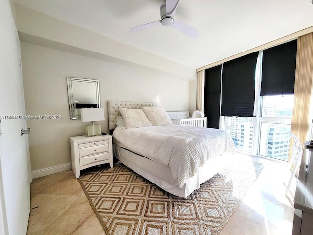 bedroom featuring baseboards and a ceiling fan