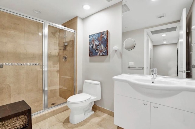 bathroom with baseboards, toilet, tile patterned flooring, vanity, and a shower stall