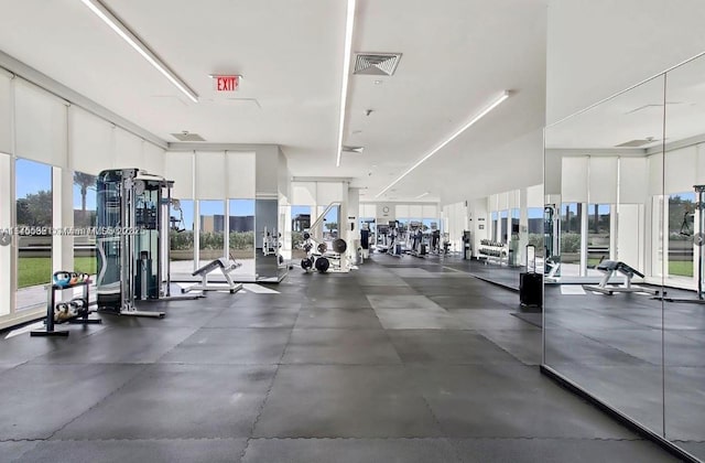 workout area featuring visible vents and a wall of windows