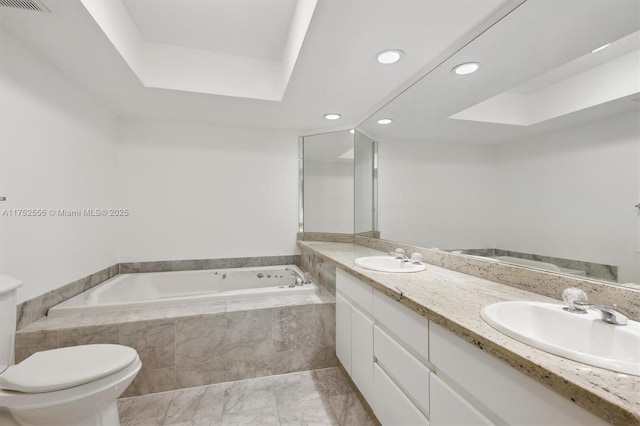 full bath featuring a garden tub, a sink, toilet, and double vanity