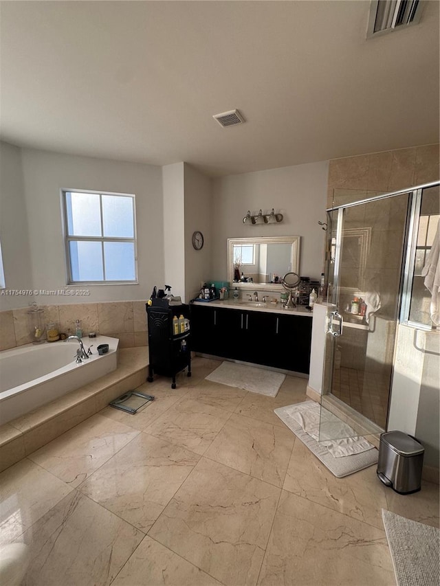 bathroom featuring marble finish floor, vanity, visible vents, and a stall shower