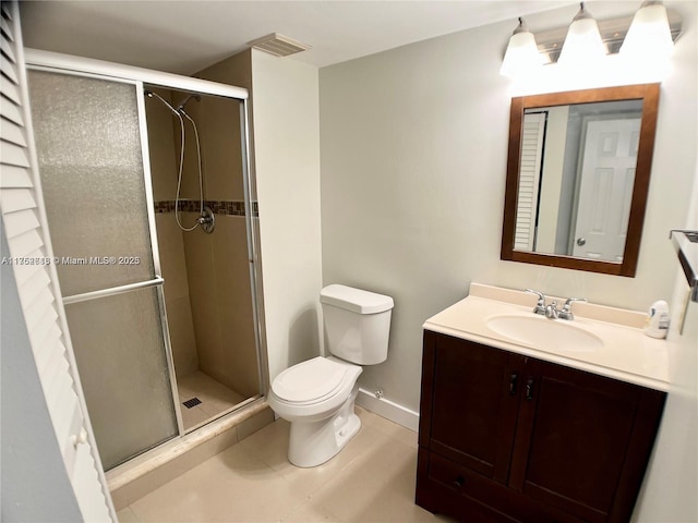 bathroom featuring toilet, visible vents, vanity, baseboards, and a stall shower