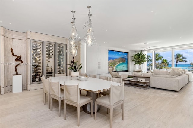 dining room featuring a wall of windows and light wood finished floors