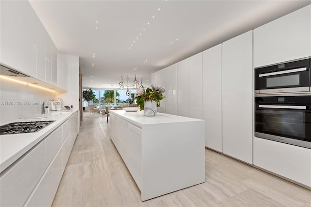 kitchen featuring a center island, white cabinetry, stainless steel gas cooktop, and modern cabinets