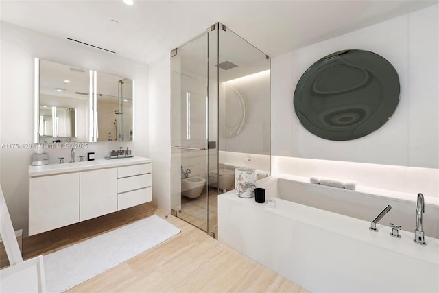 full bathroom featuring a garden tub, visible vents, vanity, a shower stall, and a bidet